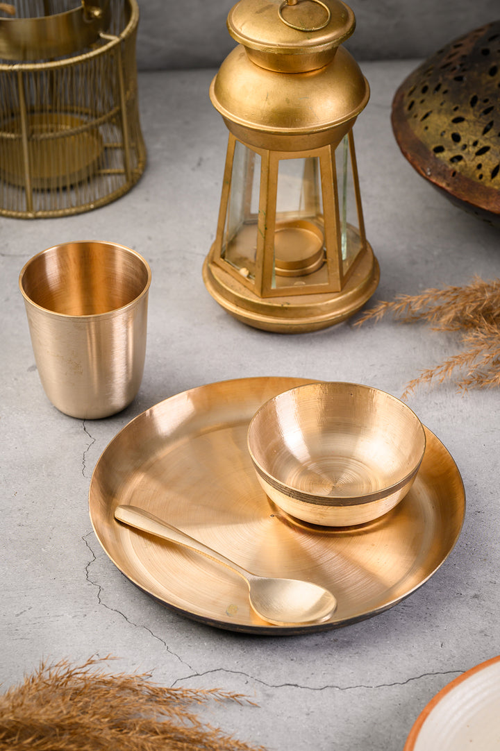 Kansa Baby Dinner Set / Baby Gift Set featuring a bronze plate, bowl, spoon, and glass on a styled table.