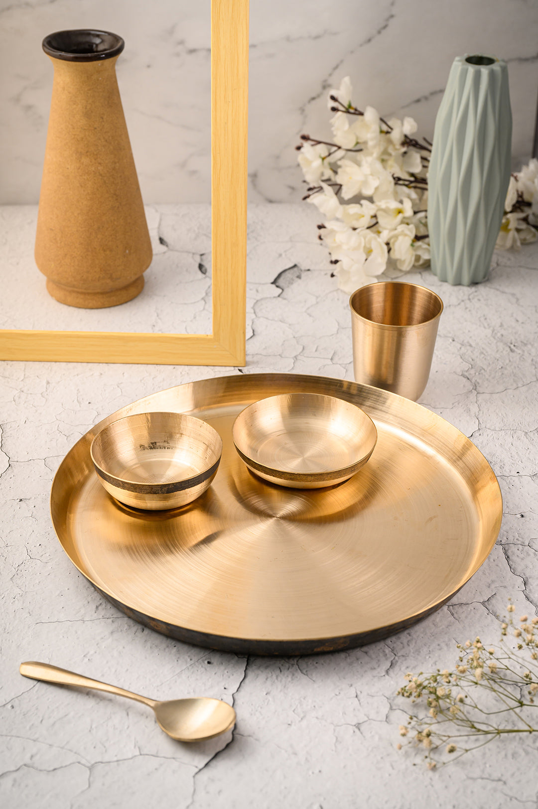 Kansa Dinner Set featuring a large plate, small bowls, and metal cup, showcasing handmade bronze craftsmanship.