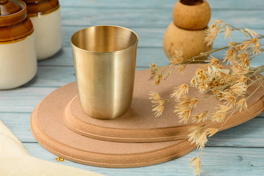 Drinking water from a Kansa bronze glass — Kansawala